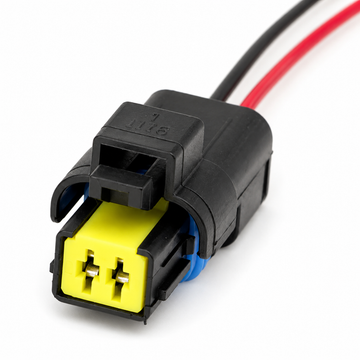 A black electrical connector with a bright yellow male plug and red and black wires extending from the back, shown on a white background.