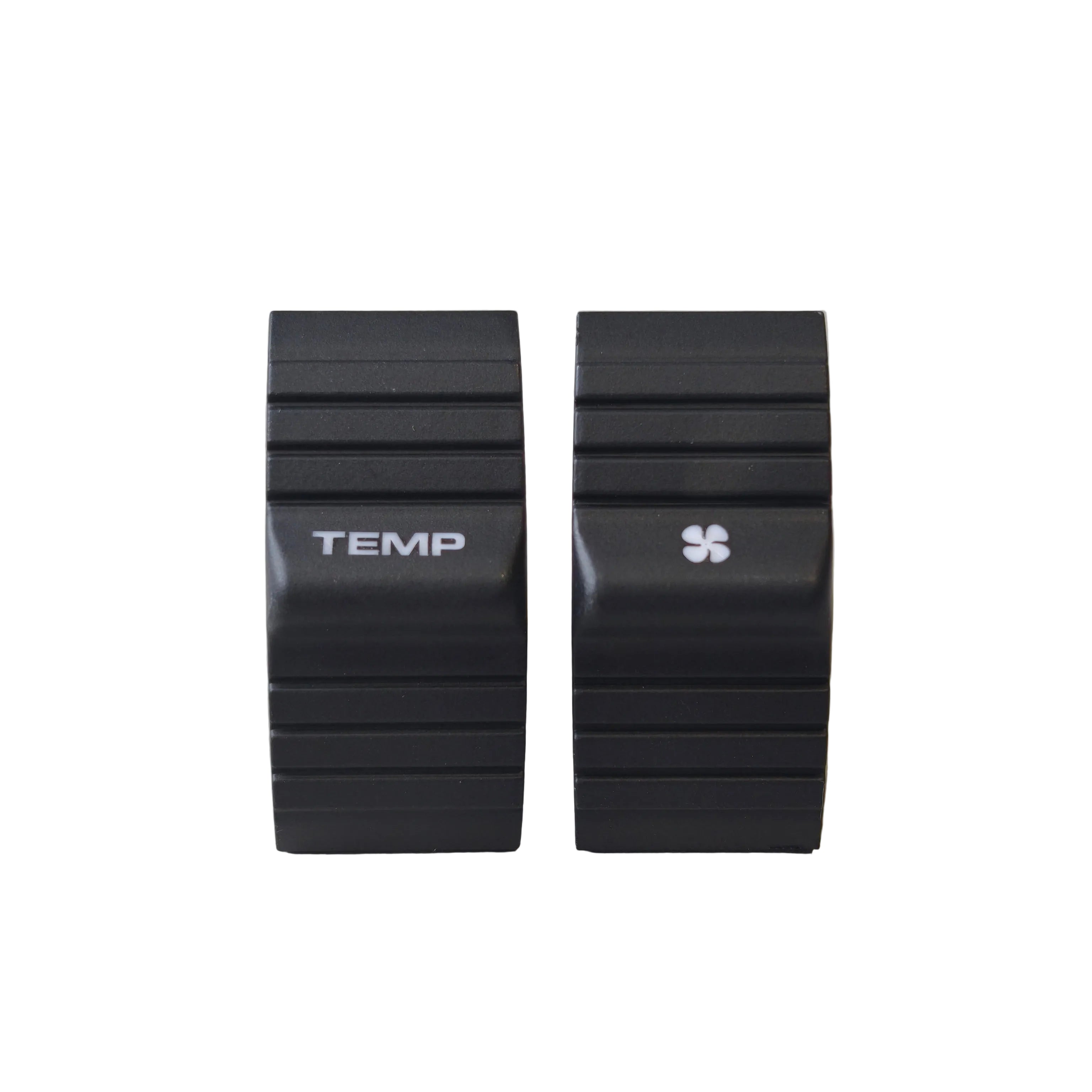 Two black ribbed electronic control modules labeled TEMP and with a small four-leaf symbol, standing upright on a light gray surface.