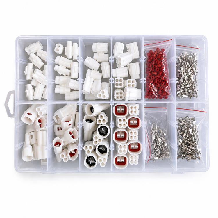 A clear plastic organizer box filled with small white electrical connectors and accessories, including red and black terminal pieces and bags of silver metal screws, photographed on a white background.